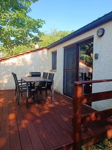 a patio with a table and chairs on a deck at Casa Gaumaise & Casa Cool in Virton