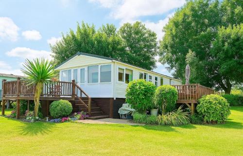 a small house with a porch and a deck at The Lodge in Newport