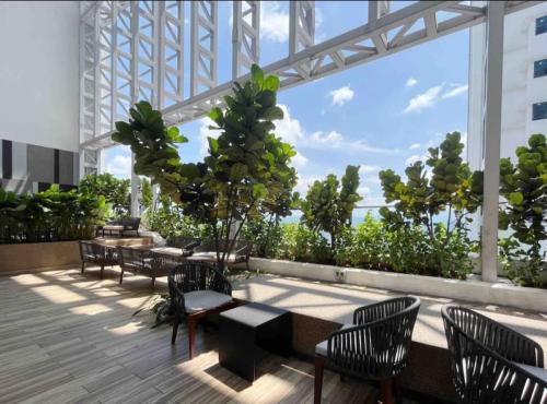 a patio with tables and chairs in a building at The Luxe By klcc infinitum in Kuala Lumpur