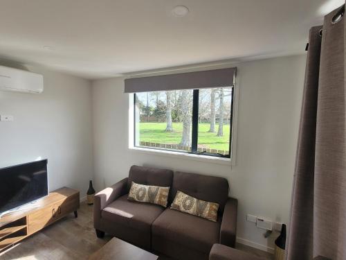 a living room with a couch and a window at Welcome to your cozy retreat! two-bedroom home in Flagstaff in Hamilton