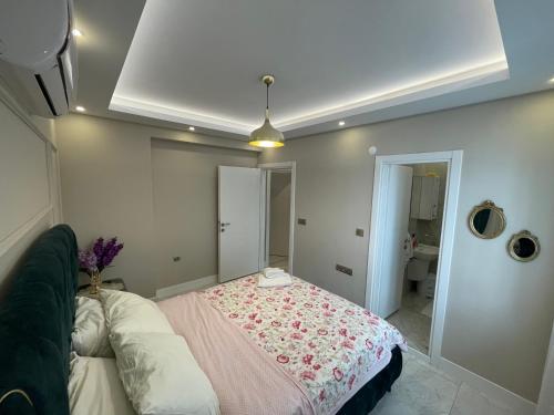 a bedroom with a bed with a pink blanket at White Pearl in Trabzon