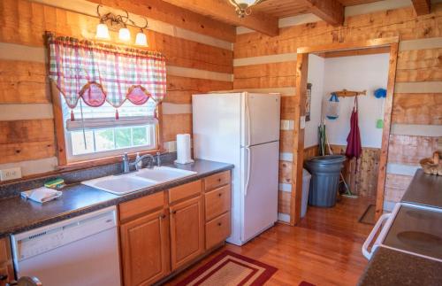 a kitchen with a white refrigerator and a sink at River Access, VIEWS, Sleeps 8, Fire Pit in Brownwood