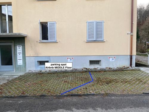 a building with a sign on the side of it at Moderne Wohnung mit Parkplatz in Ostermundigen