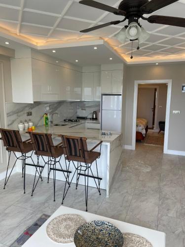 a kitchen with a table and chairs and a ceiling fan at White Pearl in Trabzon