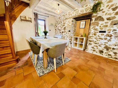 a dining room with a table and chairs at Gîte du NL Ranch in Saint-Marcel-de-Félines
