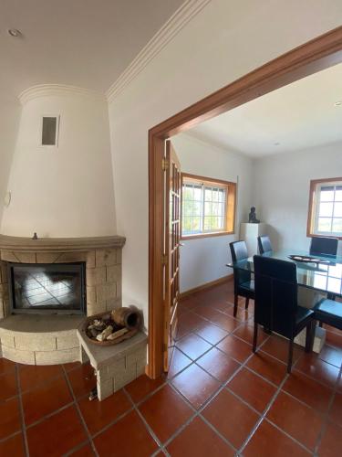 a living room with a fireplace and a table at Vivenda Juliano Freitas