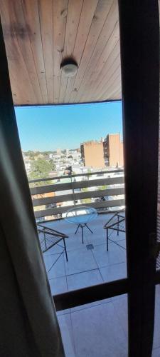 a view of a balcony with tables and chairs at María in Paraná
