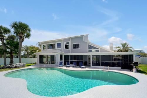 a house with a swimming pool in front of it at Manatee By The Bay in Crystal River