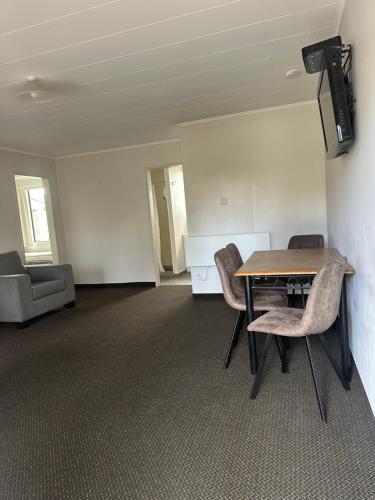 an empty room with a table and chairs at Cherylea Motel in Blenheim