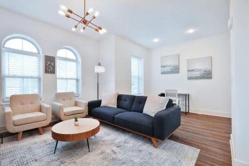 a living room with a blue couch and a chair at Contemporary Vintage Home Near Downtown in Bexley