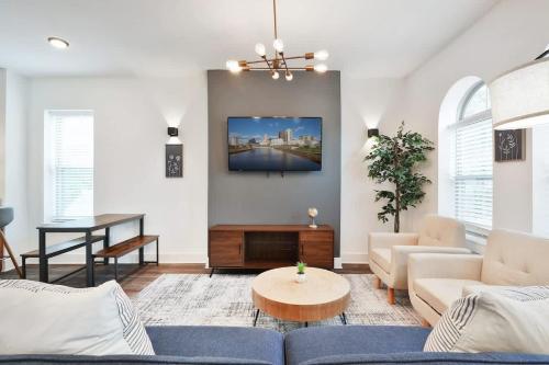 a living room with a couch and a table at Contemporary Vintage Home Near Downtown in Bexley