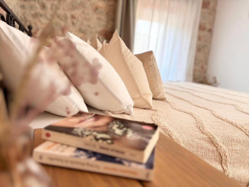 a bedroom with a bed with two books on it at Casa Rustivéra - Island Hvar in Vrbanj