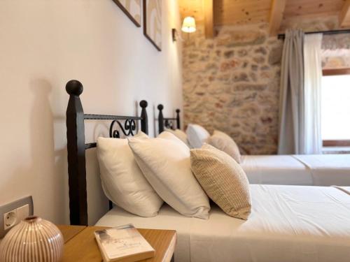 a bedroom with a bed with white pillows at Casa Rustivéra - Island Hvar in Vrbanj