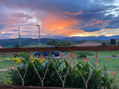 a truck parked in a field with a sunset at Sendero de la Laja Cabaña 1 in San Gil