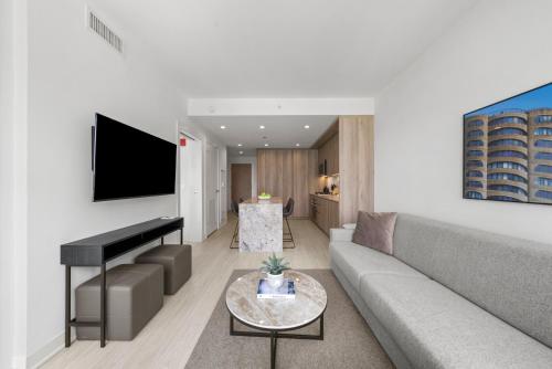 a living room with a couch and a piano at Level Chicago Fulton Market in Chicago