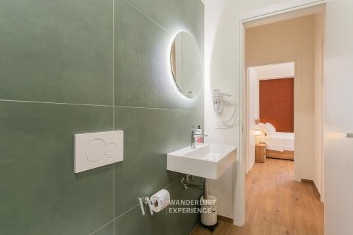 a bathroom with a sink and a mirror at Wanderlust Experience Le dimore di Alice in Bitonto