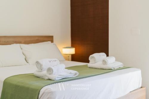 two towels are sitting on top of a bed at Wanderlust Experience Le dimore di Alice in Bitonto