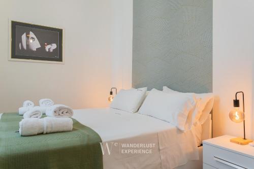a bedroom with a bed with towels on it at Wanderlust Experience Le dimore di Alice in Bitonto