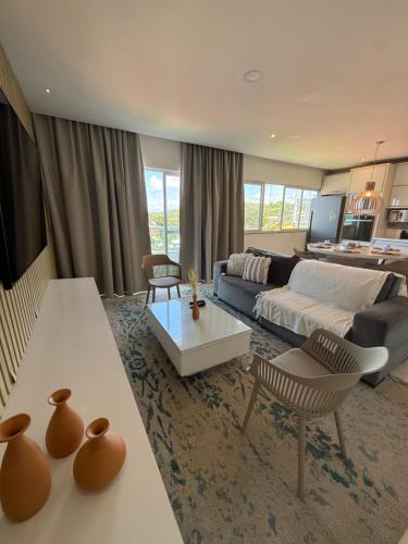 a living room with a couch and a table at Casa Ribeiro Morro de São Paulo in Morro de São Paulo