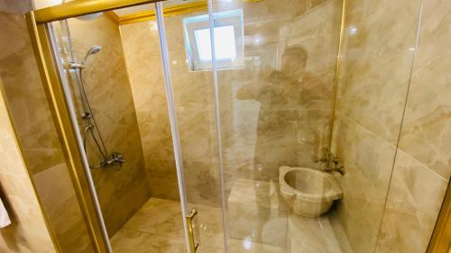 a bathroom with a shower and a toilet at White Pearl in Trabzon