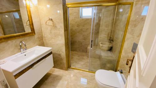 a bathroom with a shower and a sink and a toilet at White Pearl in Trabzon