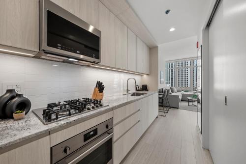 a kitchen with a stove and a counter top at Level Chicago Fulton Market in Chicago