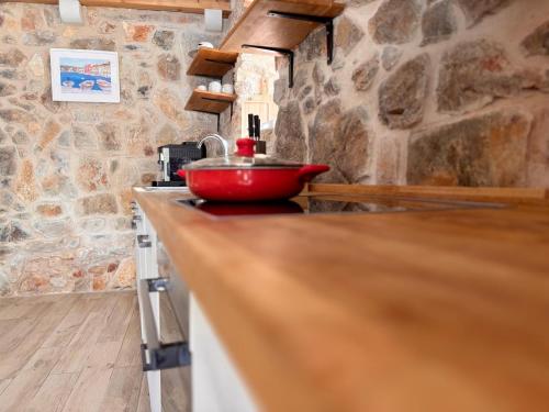 a red bowl on a counter in a kitchen at Casa Rustivéra - Island Hvar in Vrbanj