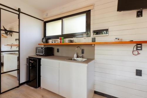 a small kitchen with a sink and a window at Tiny House Las Compuertas in Las Compuertas