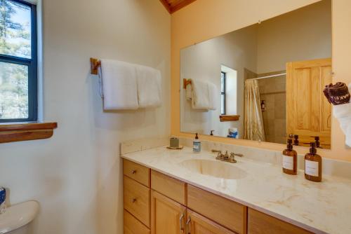 a bathroom with a sink and a mirror at Mtn-View Deck: Cabin Getaway in Angel Fire in Angel Fire