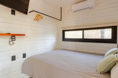 a bedroom in a tiny house with a bed at Tiny House Las Compuertas in Las Compuertas