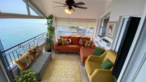 a living room with a couch and chairs on a balcony at White Pearl in Trabzon