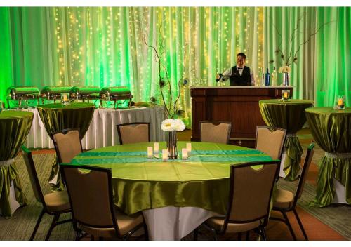 a man standing at a podium in a room with a table at Cherokee Casino West Siloam Springs Resort in West Siloam Springs