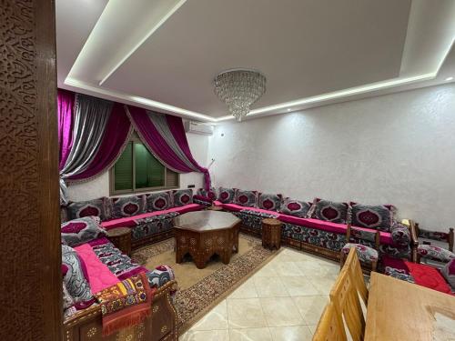 a living room with couches and a table at 3 bedroom apartment with living room and terrace 90metre in El Harhoura