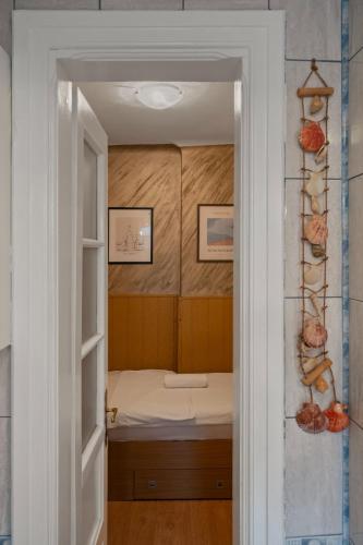 a door leading into a room with a bed at Interbelic Villa near Old Town in Bucharest
