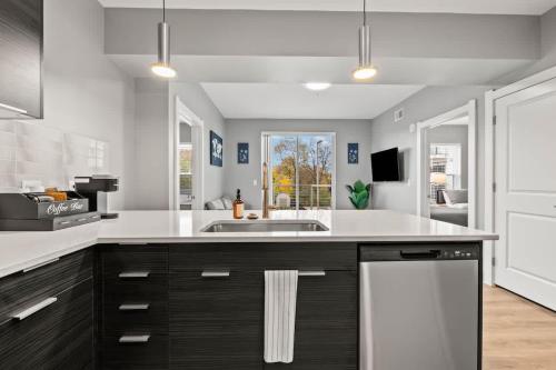 a kitchen with a sink and a counter at Modern Luxury in Columbus Near Downtown & OSU in Fawcett Center For Tomorrow Heliport