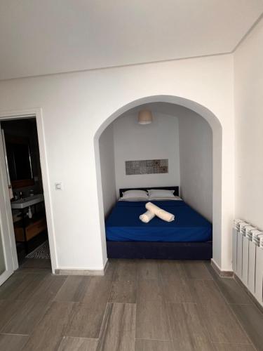 a bedroom with a bed with a blue bedsheet and two towels at Sofia House sidi bou said in Sidi Bou Saïd