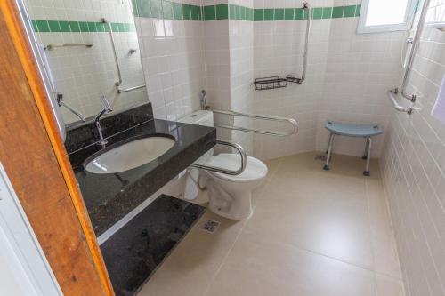 a bathroom with a sink and a toilet at Pousada Assojuris in Caraguatatuba