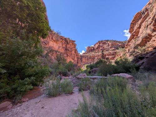 a trail through a canyon with rocks and trees at Gateway Glamping in Gateway