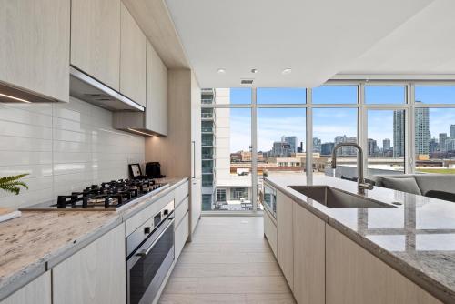 a kitchen with a view of a city skyline at Level Chicago Fulton Market in Chicago