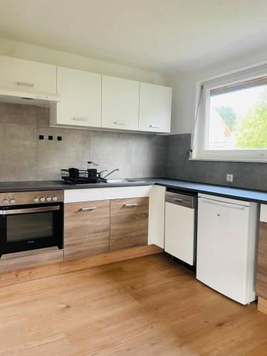 a kitchen with white appliances and a window at Wohnung Nähe Schwäbisch Gmünd in Lorch