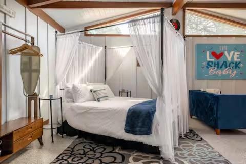 a bedroom with a bed with a canopy at The Love Shack in Carmel