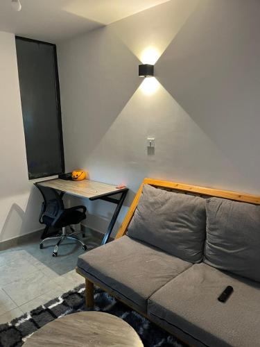 a room with a bed and a desk with a desk at Tsavo Sentinel - Studio in Ongata Rongai 