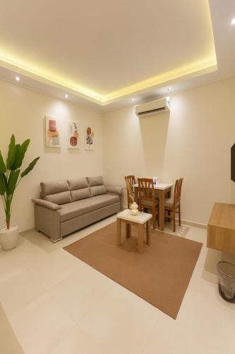 a living room with a couch and a table at Diva Suites in Hurghada