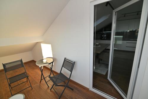 a small dining room with two chairs and a table at Lux&Spa Petko in Pirot