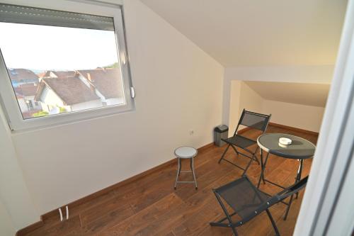 a room with a table and chairs and a window at Lux&Spa Petko in Pirot