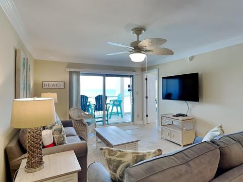 a living room with a couch and a flat screen tv at Regency Towers #505 West in Oriole Beach