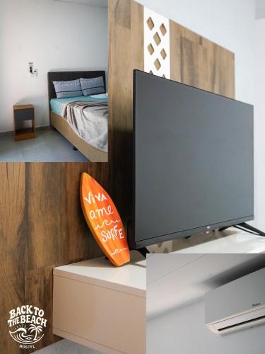 a living room with a tv and a bed at Back to the Beach Hostel - Pipa in Pipa