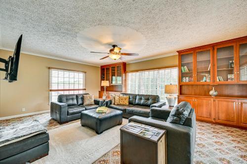 a living room with leather furniture and a ceiling fan at Rural and Private Dover Retreat Close to Wineries! in Sugarcreek