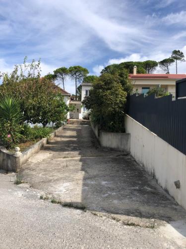 an empty driveway in front of a house at Casa da Oliveira 