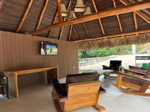 a living room with chairs and a couch and a table at hacienda hotel texas in Durania